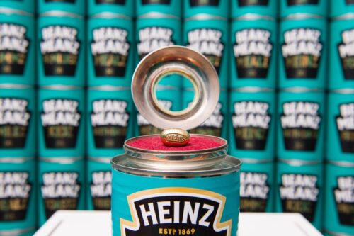 An open can of beans showing a golden baked bean