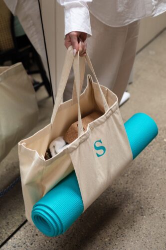 A yoga mat in a Sleepeezee branded tote bag